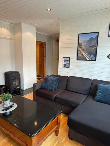 a living room with a couch and a coffee table at Northern Dream Lofoten in Hovdan