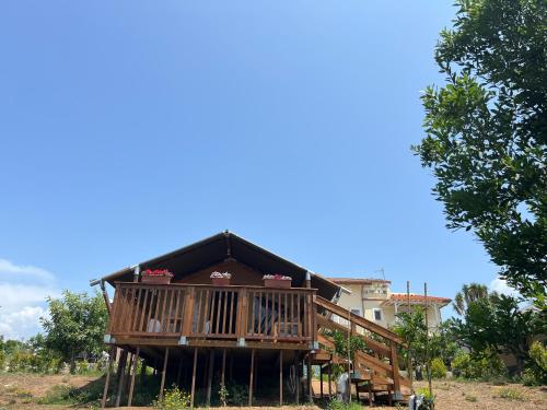 a large house with a balcony on top of it at CàSolare Glamping Experience Sperlonga in Sperlonga