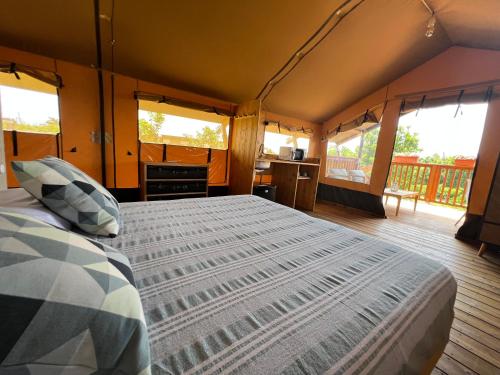 a bedroom with a bed in a tent at CàSolare Glamping Experience Sperlonga in Sperlonga