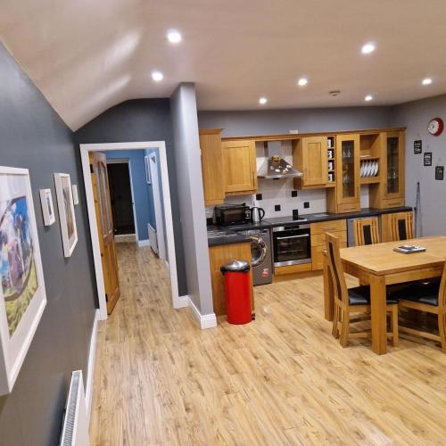a kitchen with a table and a dining room at The Corner Apartment in Hacketstown
