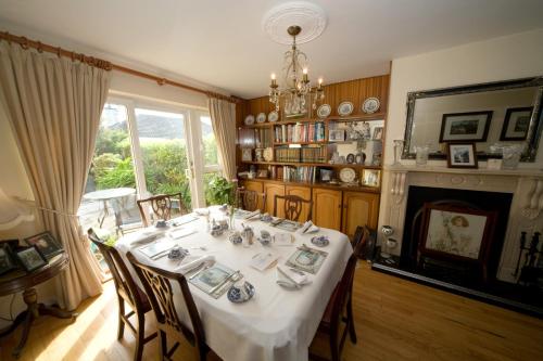 a dining room with a table and a fireplace at Danabel B&B in Kinsale