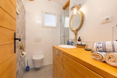 a bathroom with a sink and a mirror at Vila Mare in Risika