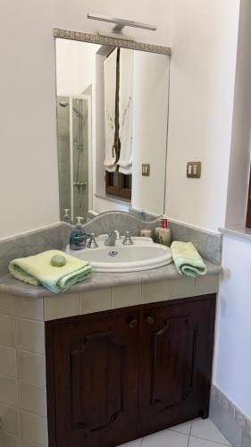 a bathroom with a sink and a mirror at Agira Royal Central Rooms in Agira