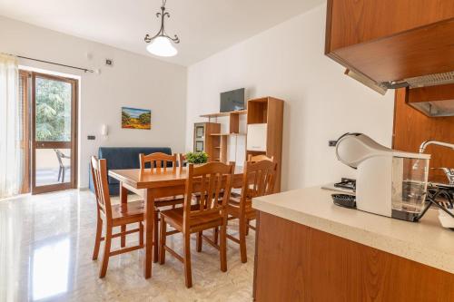 a kitchen and dining room with a table and chairs at Villa il panorama sullo Ionio in Tuglie