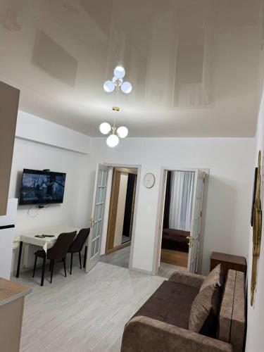 a living room with a couch and a table at LiluHome in Tbilisi City