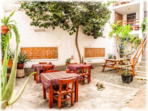 a group of tables and chairs in a courtyard at ATMA Hostel & Yoga in Huanchaco