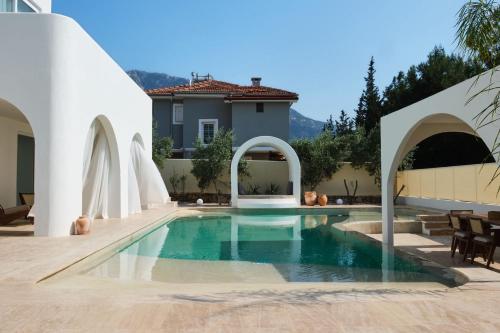 a swimming pool in a backyard with a house at Villa NeoX with 2 Pools, Jacuzzi, Sauna & Minigolf in Fethiye