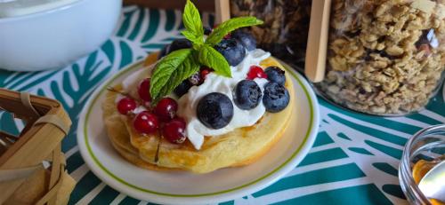a pastry with berries on a plate on a table at Chambre d'Hôtes "La petite Dormeuse" in Comps