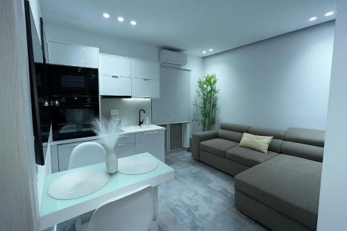 a white living room with a couch and a table at KLEOPATRA'S Luxury Suite in Preveza