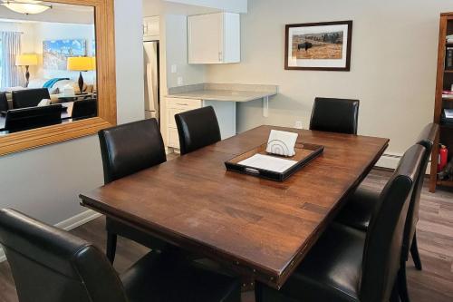 a dining room table with chairs and a laptop on it at On Gore Creek, Pet Friendly, Steps from Free Bus Stop & Great Value in Vail