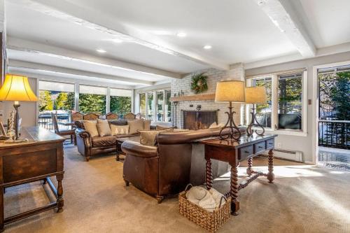 a living room with a couch and a fireplace at Private Hot Tub and Sauna, Right on Fairway, Minutes From Vail Village & Golden Peak in Vail