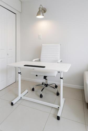 a white desk with a laptop on top of it at Tempurpedic Queen - Laundry, Parking & EV Charger in Hollywood