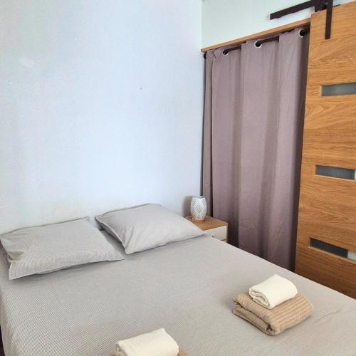 une chambre avec un lit avec deux serviettes dessus dans l'établissement T2 Cozy a 2 min à pied des plages - Parking privé, à Palavas-les-Flots