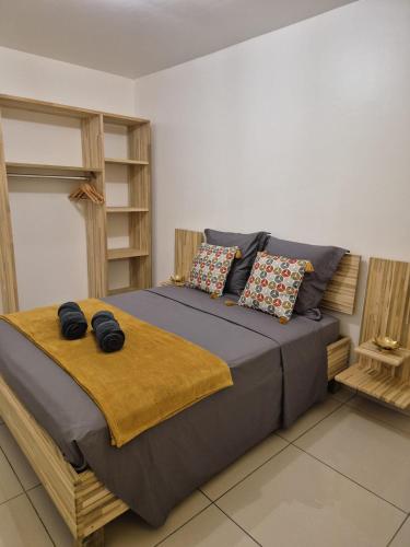 a bedroom with a large bed with pillows at VILLAS Lush Eden in Vieux-Habitants