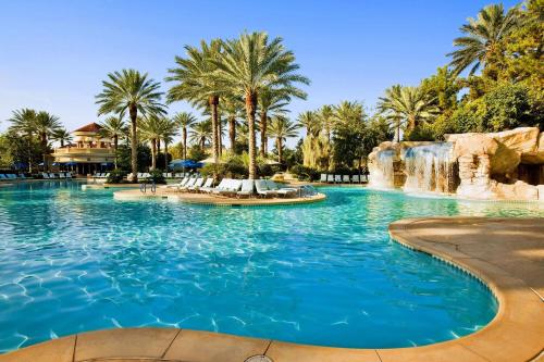 a swimming pool with a waterfall in a resort at JW Marriott Las Vegas Resort & Spa in Las Vegas