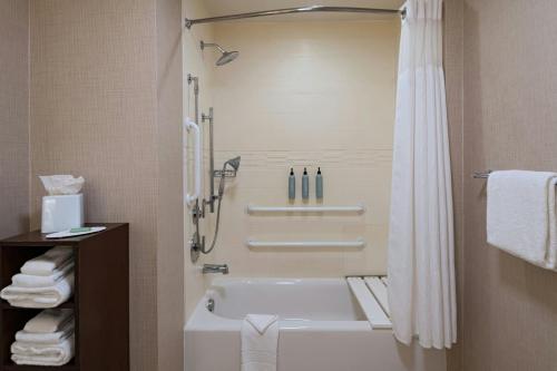a bathroom with a white tub and a shower at Residence Inn by Marriott Houston NW Cypress in Cypress