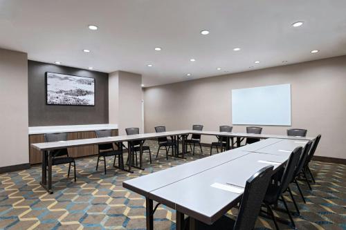 a conference room with tables and chairs and a whiteboard at Residence Inn by Marriott Houston NW Cypress in Cypress