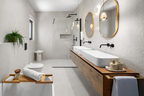 a bathroom with a sink and two mirrors at NEW! Villa Aria Relax – Your Private Oasis in Bisko Village in Bisko