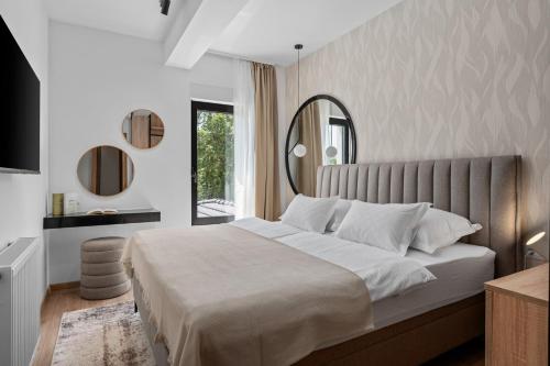 a bedroom with a large bed with a large mirror at NEW! Villa Aria Relax – Your Private Oasis in Bisko Village in Bisko