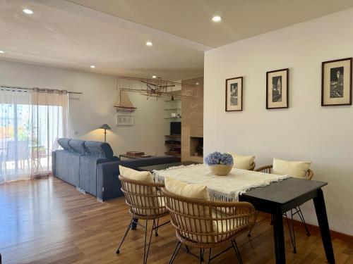 a living room with a table and chairs and a couch at Bella Cena in São Roque