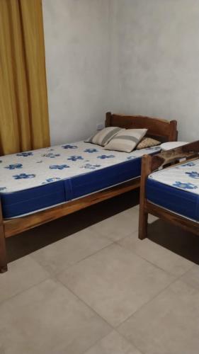 two beds sitting in a room with at Casa en Amaicha in Amaicha del Valle