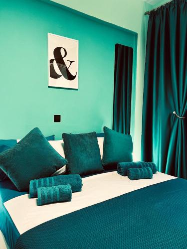 a bed with blue walls and blue pillows on it at Bella Vista in Balíon