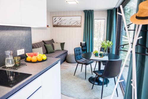 a kitchen and living room with a couch and a table at Rahusalu Flow in Laulasmaa