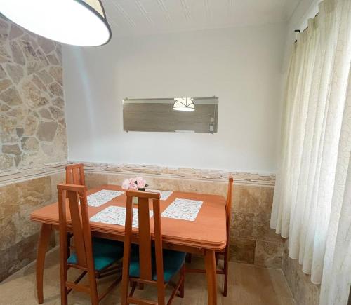 a dining room table with two chairs and a window at Casa Burriana con sauna in Burriana