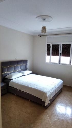 a bedroom with a large bed and two windows at Appartement bayo aya in Berkawe