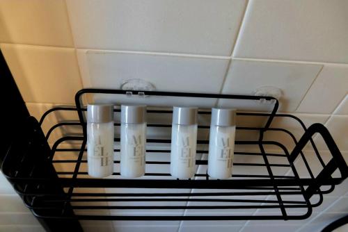 a cluster of white candles hanging from a rack at Mansarda in Osijek