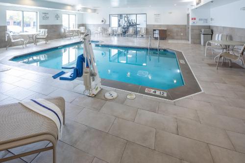 a swimming pool in a hotel room with a pool at Holiday Inn Express & Suites Chicago West - St Charles by IHG in Saint Charles