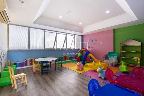 a childs play room with a table and play equipment at Barra Palace Hotel in Rio de Janeiro