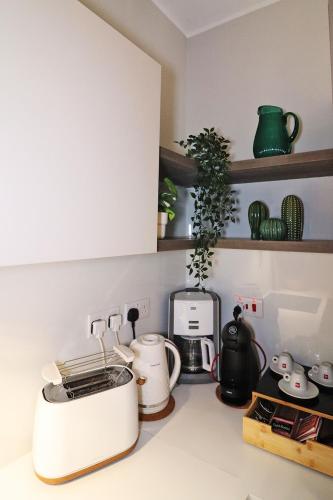 a kitchen counter with a toaster and a coffee maker at Lovely holiday home next to Bus terminus in St Paul's Bay