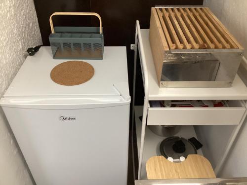a small refrigerator with a hot dog and a grill at Studio Relax Vacances Loutraki in Loutraki