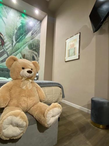 a large brown teddy bear sitting on a couch at Dimora Camilla apartment intero appartamento in Foggia
