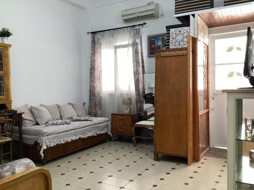 a living room with a couch and a window at Studio Relax Vacances Loutraki in Loutraki