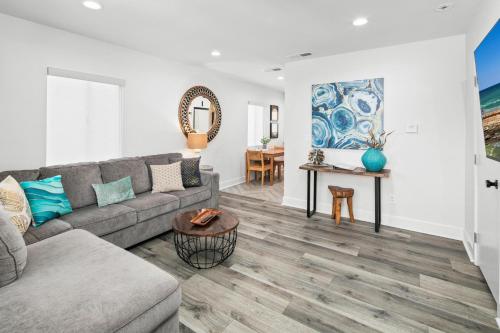a living room with a couch and a table at Modern 1 BR Apt - Walk to Ocean & Cafes in San Diego