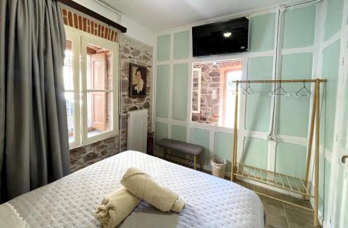 a bedroom with a bed with a stuffed animal on it at 5 Katsakouli in Mytilini