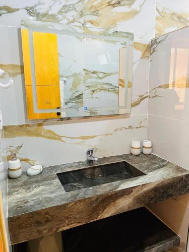 a bathroom with a sink and a mirror at Dar Ayla à DJERBA houmt souk in Houmt Souk