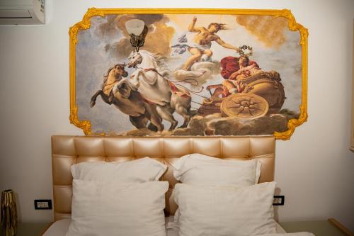 a painting above a bed in a hotel room at Hotel Marchese Boutique in Bucharest