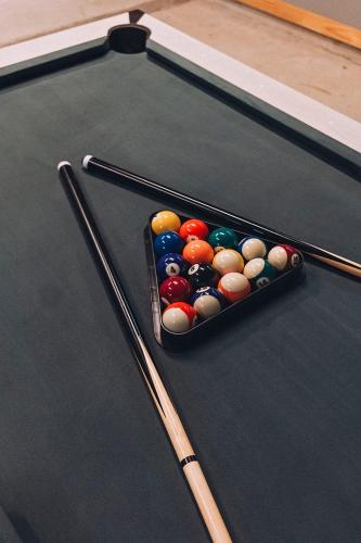 a snooker table with a container of billiard balls at Austin Retreat Hot Tub and Relaxing Patio in Austin