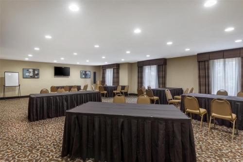 a conference room with tables and chairs and a podium at Best Western Bastrop Pines Inn in Bastrop