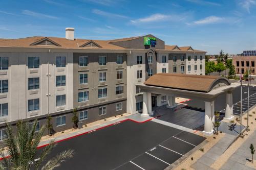 an image of ariott hotel with a large parking lot at Holiday Inn Express Fresno River Park Highway 41 by IHG in Fresno