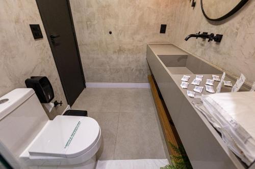 a bathroom with a toilet and a sink at Barra Palace Hotel in Rio de Janeiro