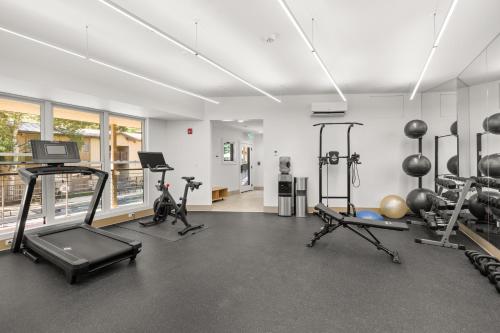 a gym with several treadmills and exercise bikes at Woodbridge Condo by Snowmass Vacations in Snowmass Village