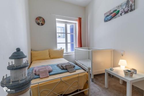 a small bedroom with a bed and a window at 'Omiros' Central Cozy House In Poro Island in Poros