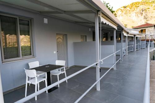 a patio with a table and chairs on a building at KAFUL APARTMENTS in Qeparo