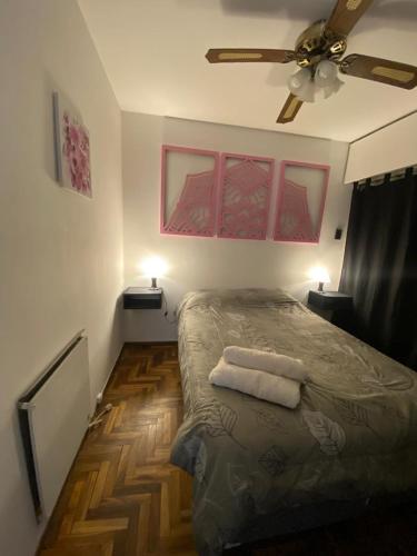 a bedroom with a bed with two towels on it at Departamento Malbec in Mendoza