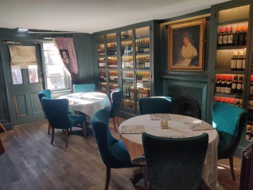 a restaurant with two tables and chairs and a fireplace at The Black Lion in Bridlington