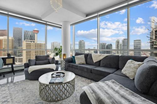a living room with a couch and a table at Urbanest - Spectacular Views & Amenities Parking in Calgary